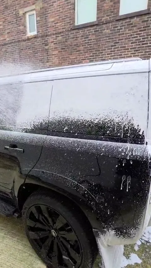 Snow foam lance on a black Land Rover Defender