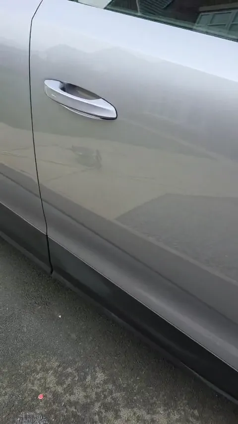 Reflections on a polished grey door panel