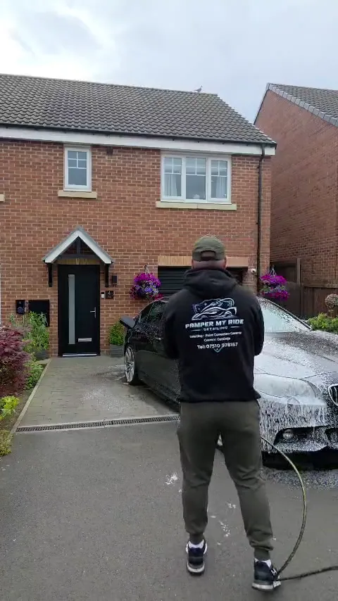 A BMW being washed on a driveway