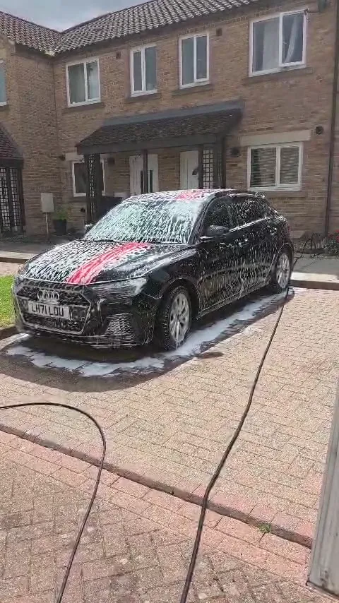 Snow foam on a black Audi A1 outside a property