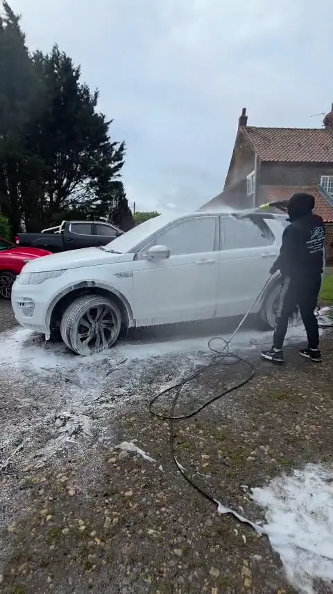 Daniel washing a white Discovery Sport