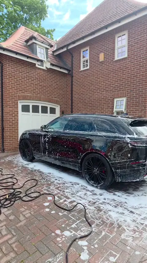 Black Range Rover covered in snow foam